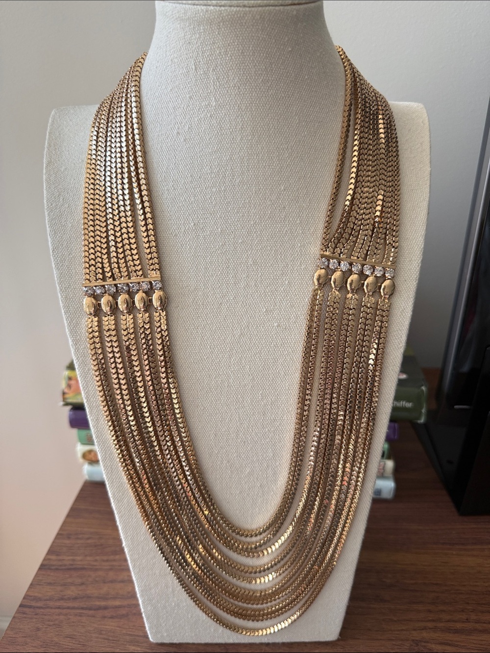 Multi Strand Gold Tone Herringbone Waterfall Necklace Accented with Rhinestones.